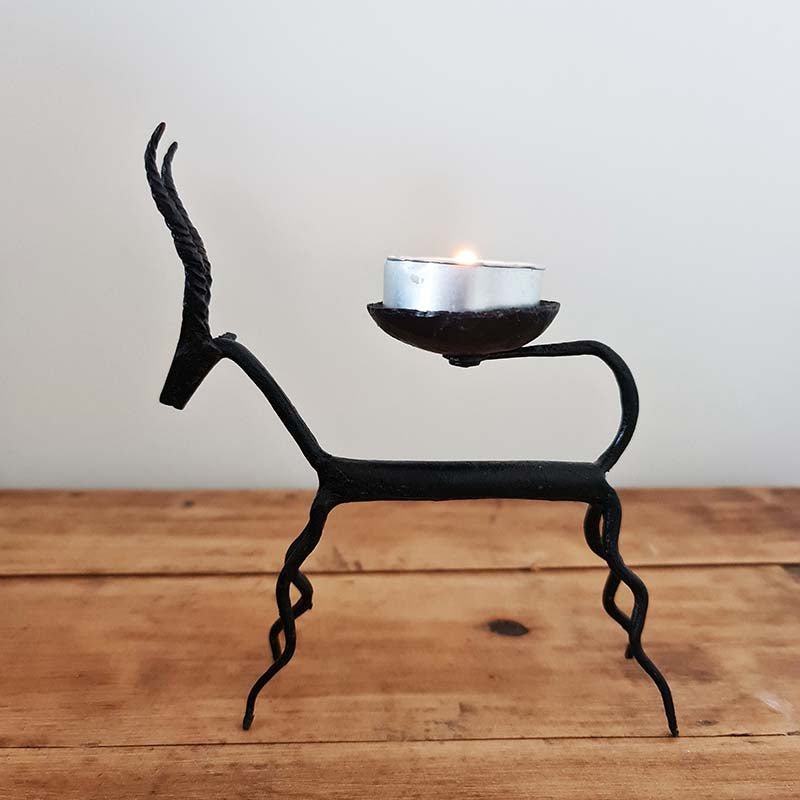 Two wrought iron tealight holders crafted by hand with deer designs in the Bastar tradition