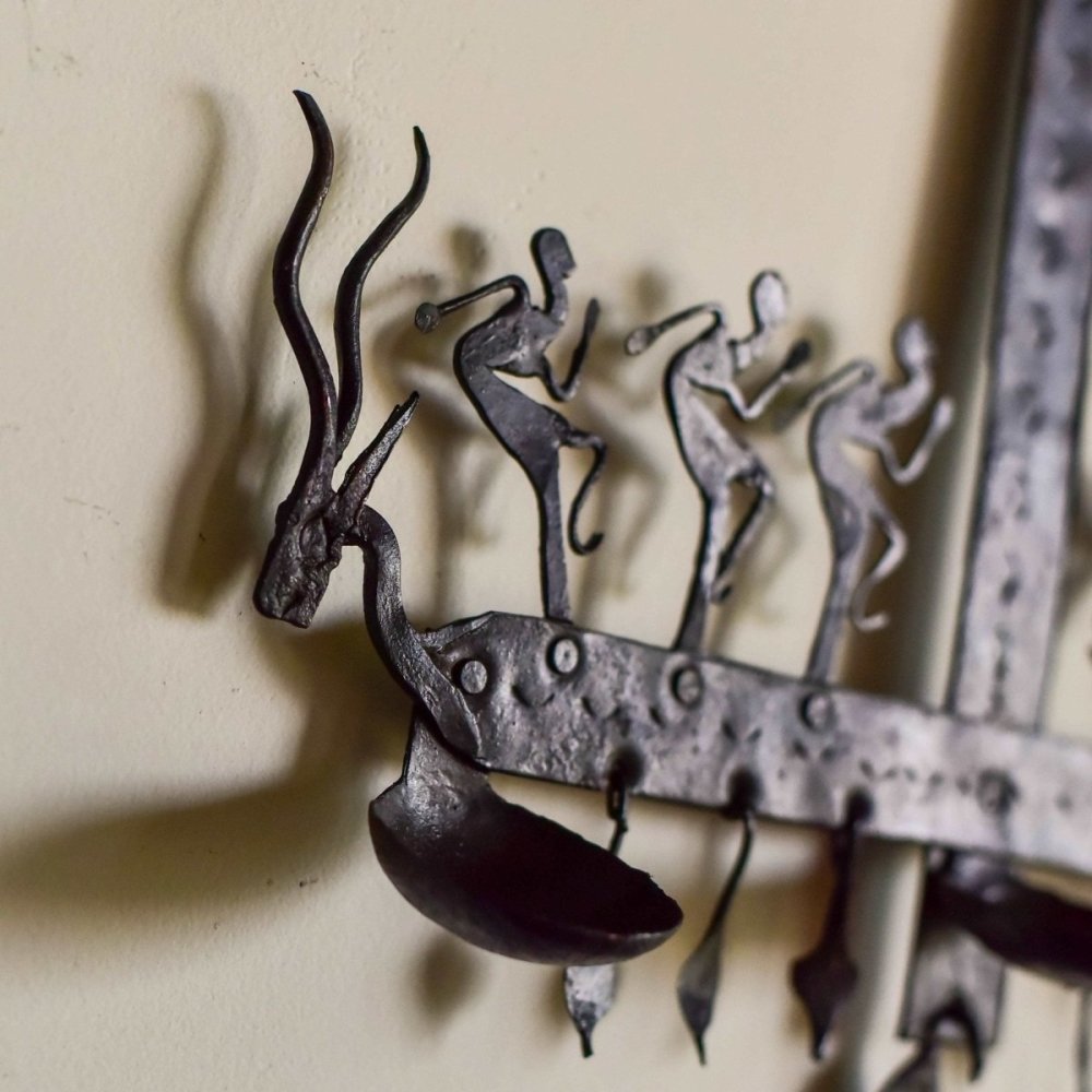 Decorative wrought iron stand inspired by Bastar tribal art, showcasing traditional designs