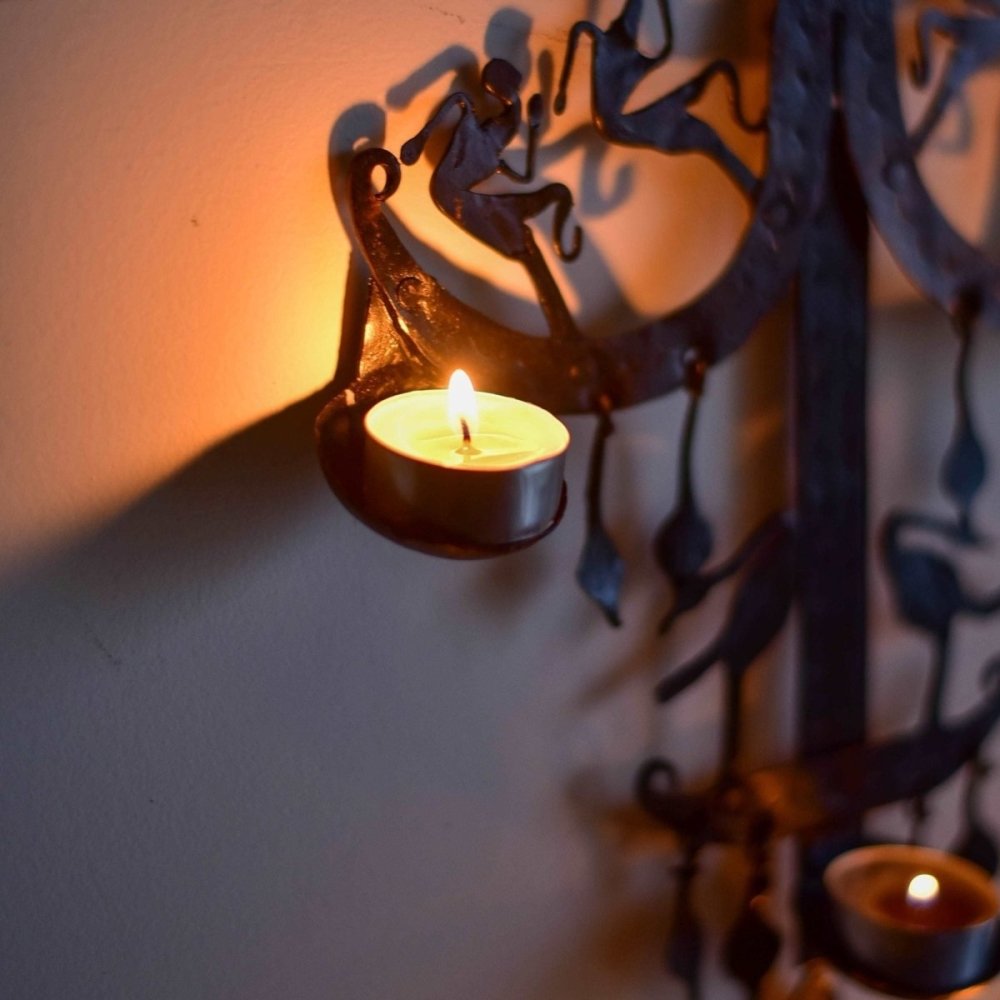 Handcrafted wrought iron candle stand with traditional Bastar tribal motifs