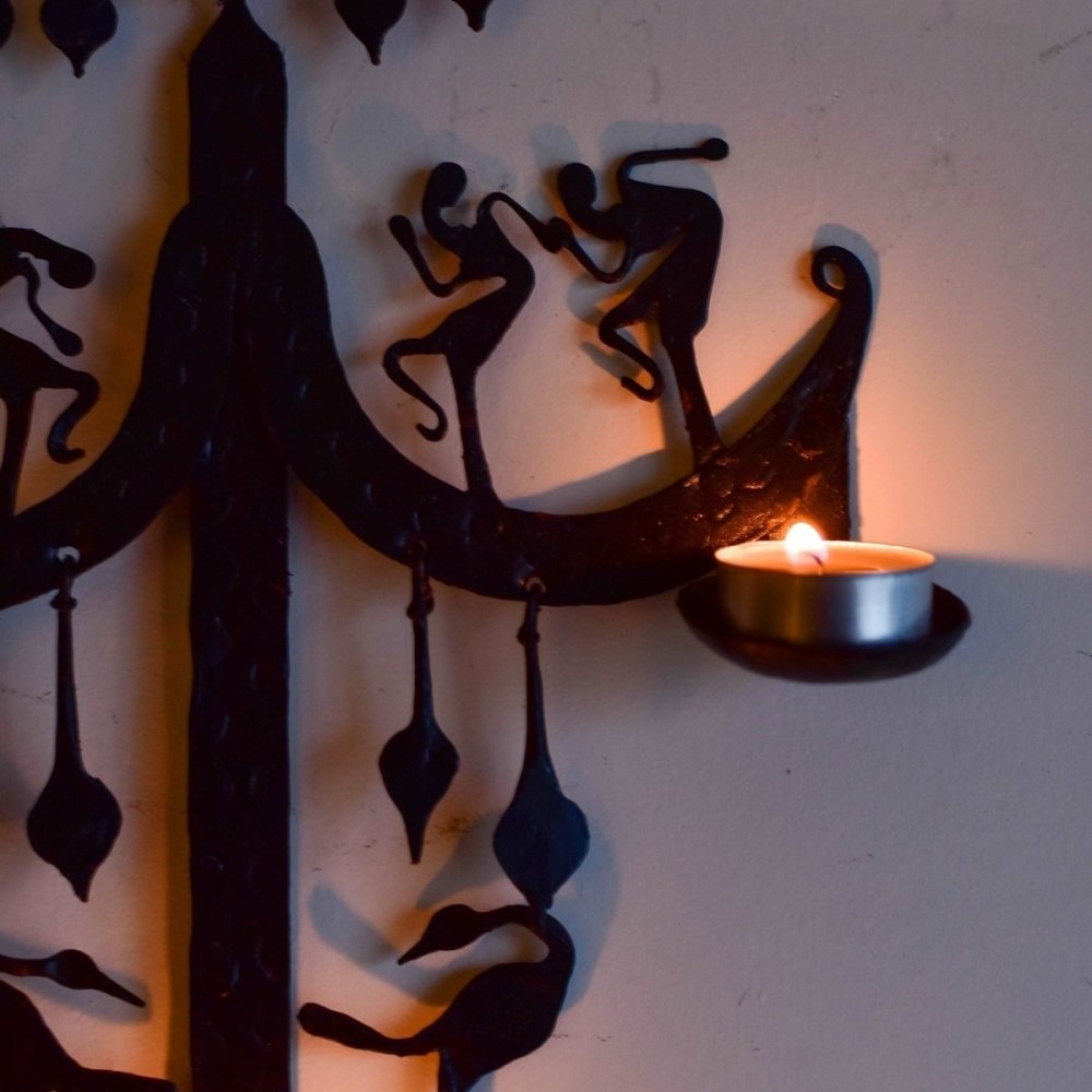 Decorative wrought iron candle stand inspired by Bastar tribal art, showcasing intricate designs