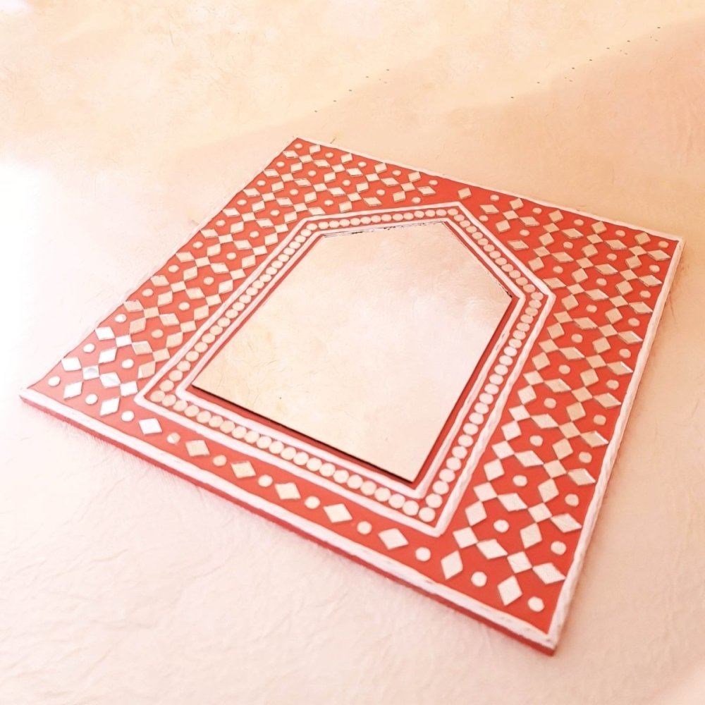 Decorative bright brick red handcrafted mud art mirror, perfect for adding a rustic touch