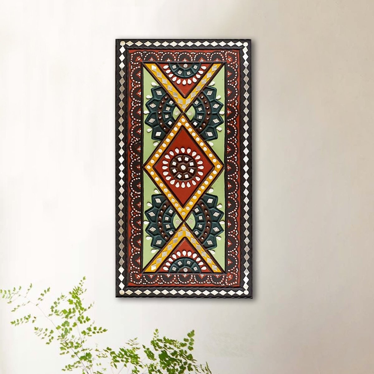 Decorative green and brown handcrafted mud and mirror work wall art, perfect for adding a rustic charm