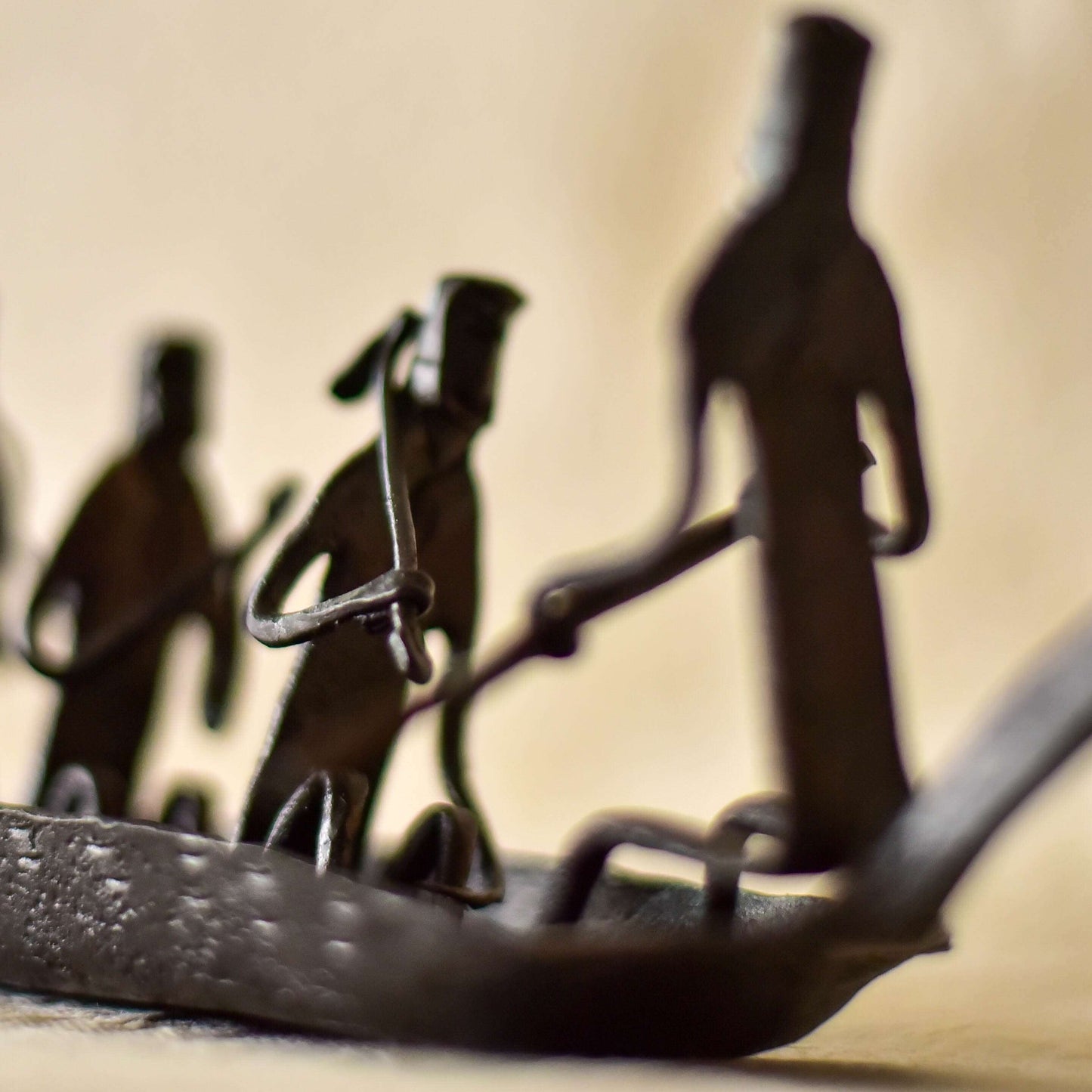Decorative wrought iron boat influenced by Bastar tribal culture, featuring symbolic motifs 