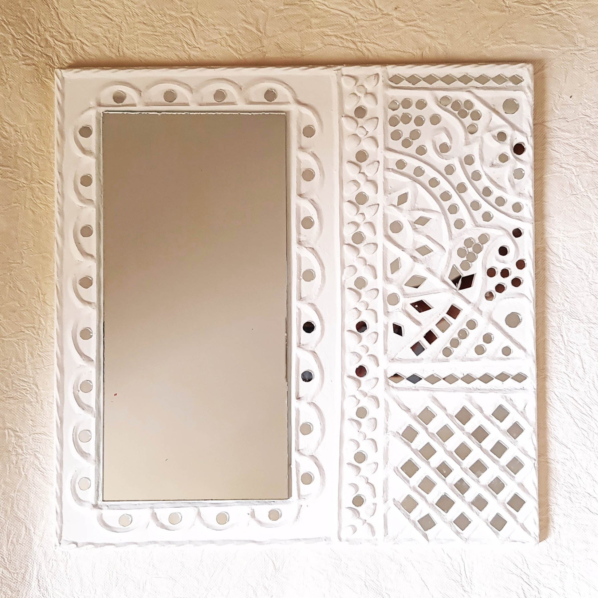 Artisanal white handcrafted mud art wall decor mirror, showcasing traditional craftsmanship 
