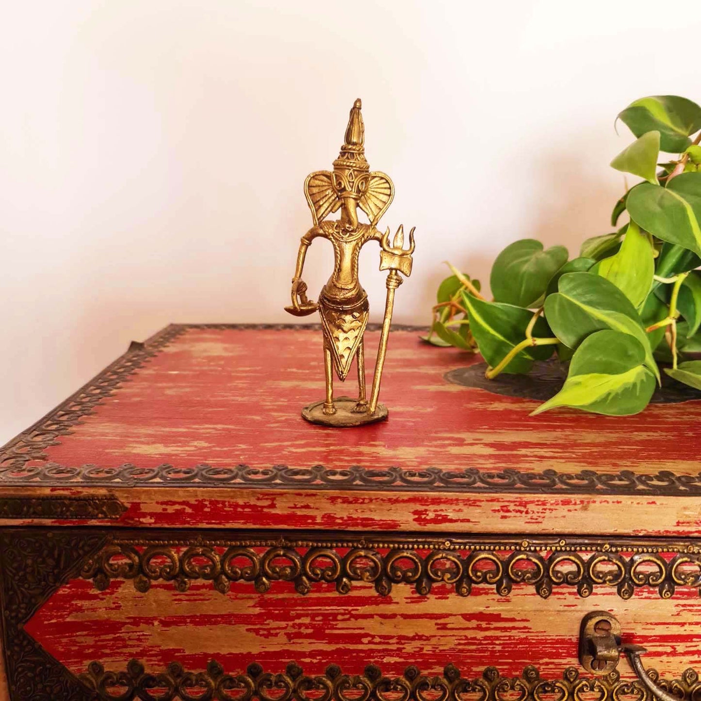 Handmade Dhokra metal figurine depicting Lord Ganesha, featuring traditional craftsmanship 