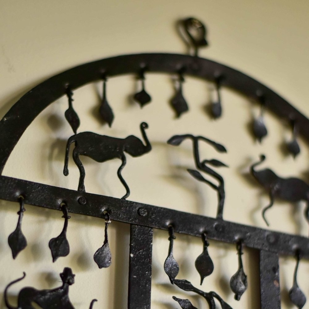 Artisanal wrought iron candle stand inspired by the Bastar tribal forest, featuring intricate designs