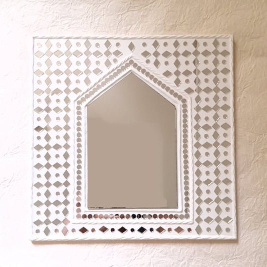 White sparkles hut-inspired mud decor mirror, adding a rustic and elegant touch to your wall 