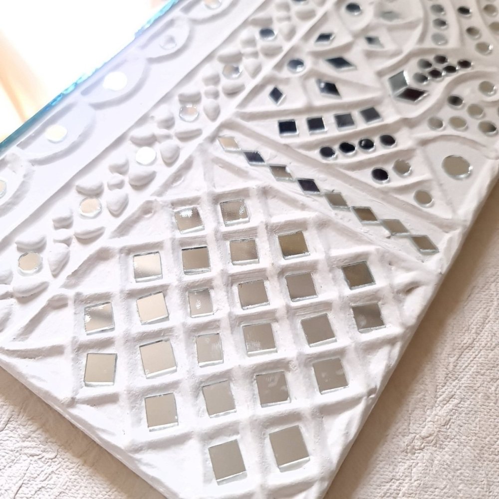 Artisanal white handcrafted mud art wall decor mirror, showcasing traditional craftsmanship 