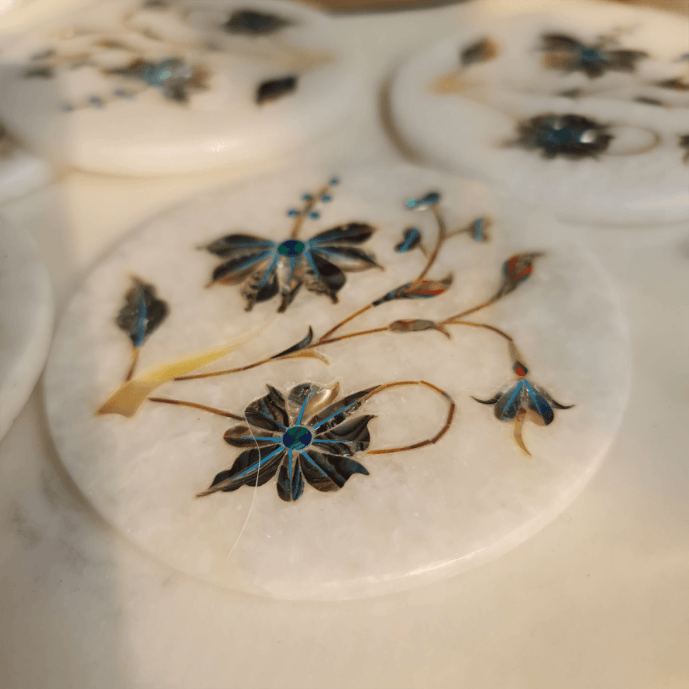 Artisanal Taj Mahal-inspired mother of pearl on marble inlay coasters, showcasing intricate craftsmanship