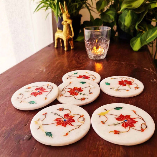 Coral marble inlay coasters inspired by the Taj Mahal, adding elegance to your tabletop decor