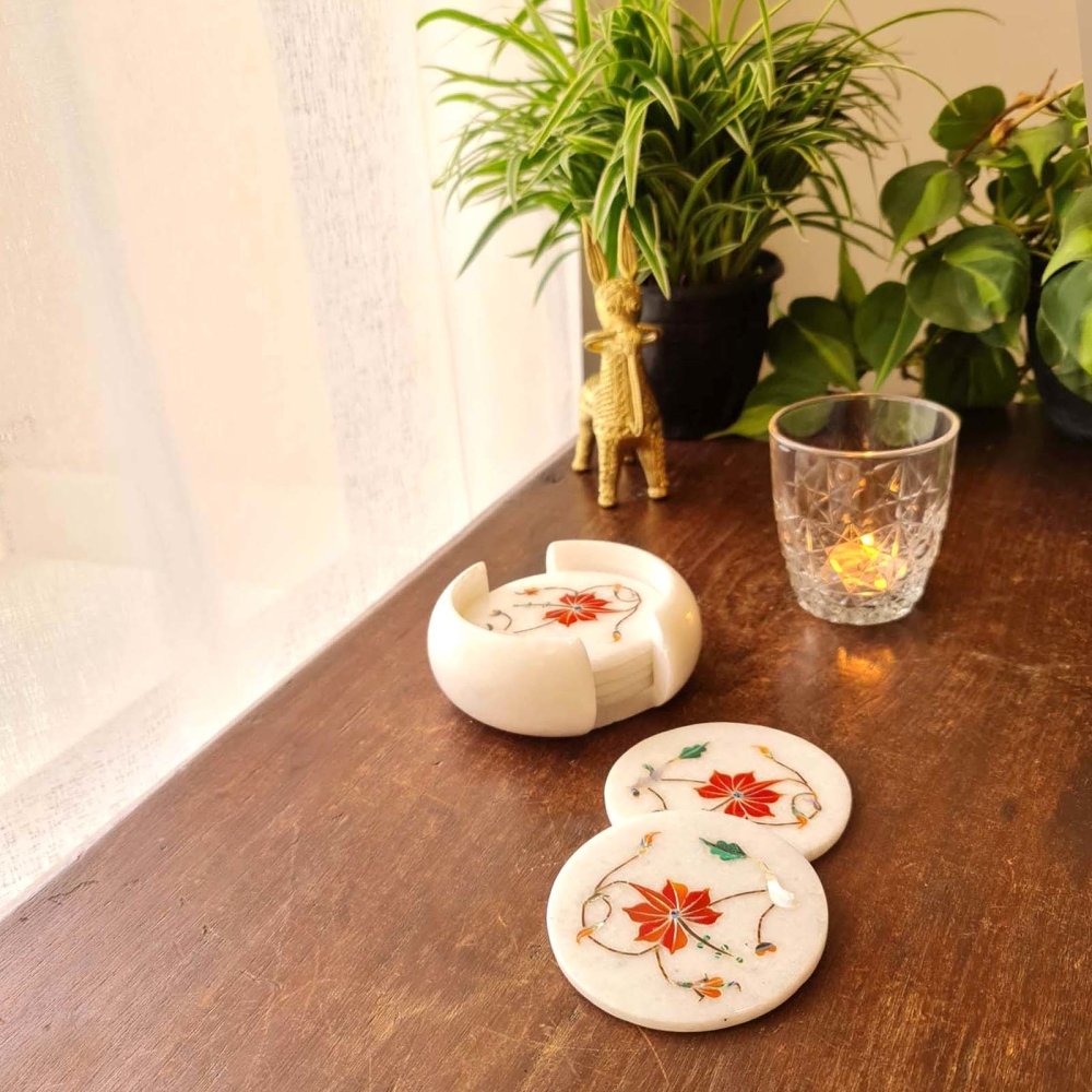Artisanal Taj Mahal-inspired coral marble inlay coasters, showcasing intricate craftsmanship