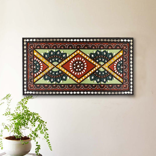 Green and brown handcrafted mud and mirror work wall art, adding a natural and earthy touch